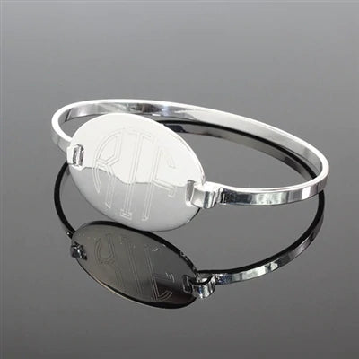 German Silver bracelet features an engraved 0.9" (24 mm) oval disk.  Shown in silver with circle font.