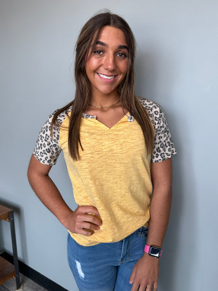 yellow top that features super cute leopard sleeve details