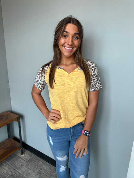 yellow top that features super cute leopard sleeve details